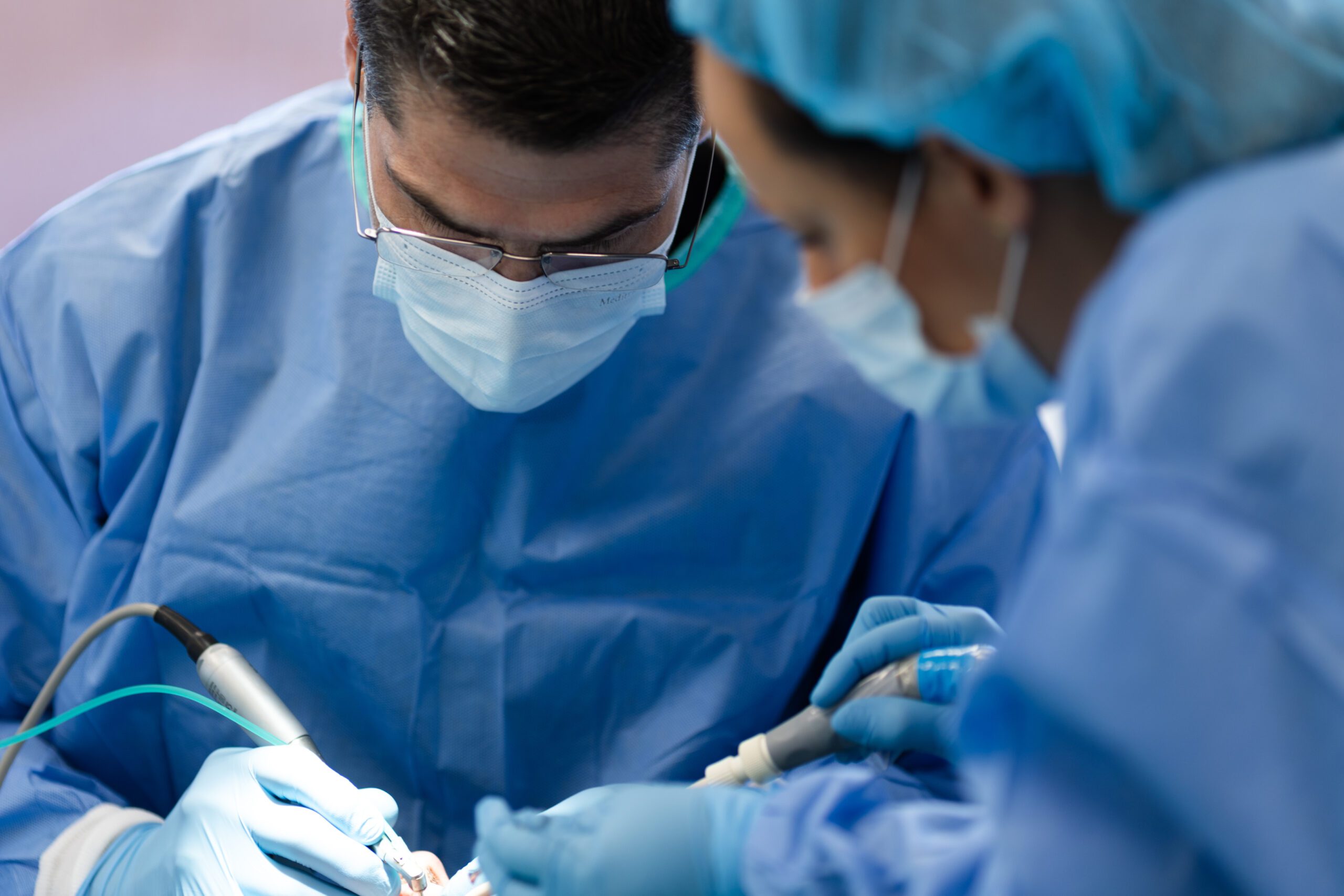 two dental staff performing dental surgery