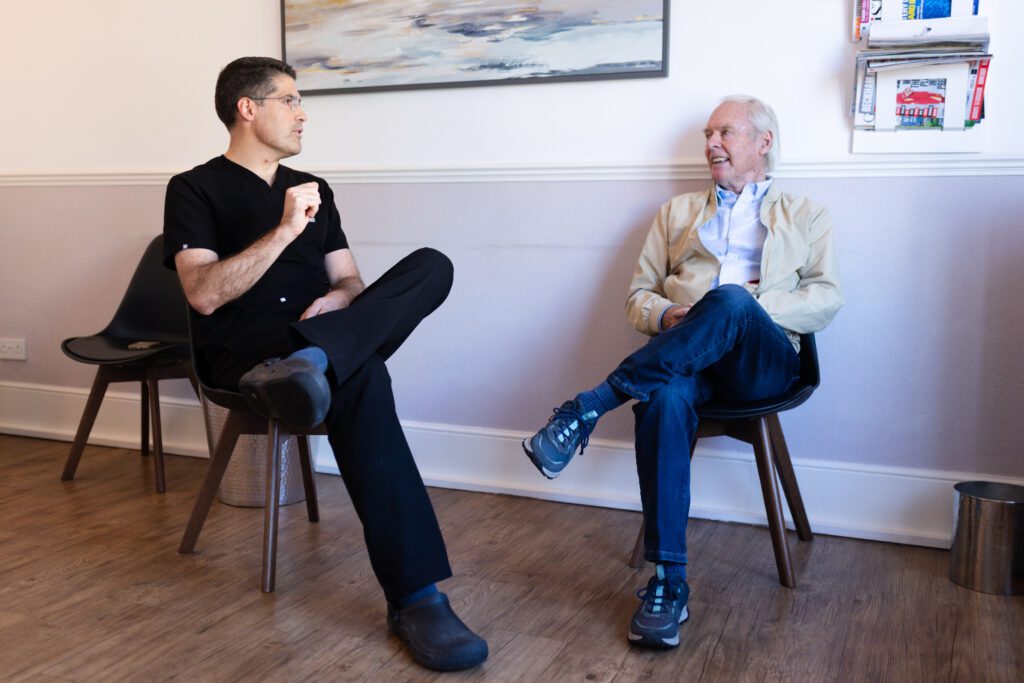 Patient looking relaxed talking to the principle dentist