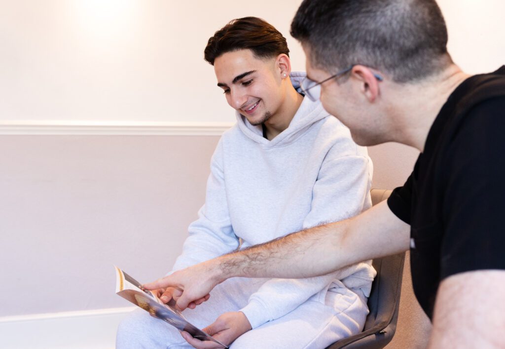 Principle dentist with a patient looking at a leaflet together