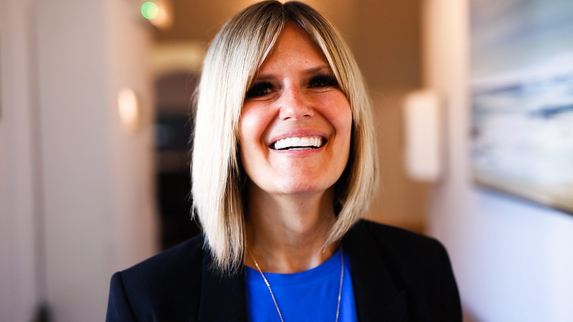 Blonde female smiling at camera