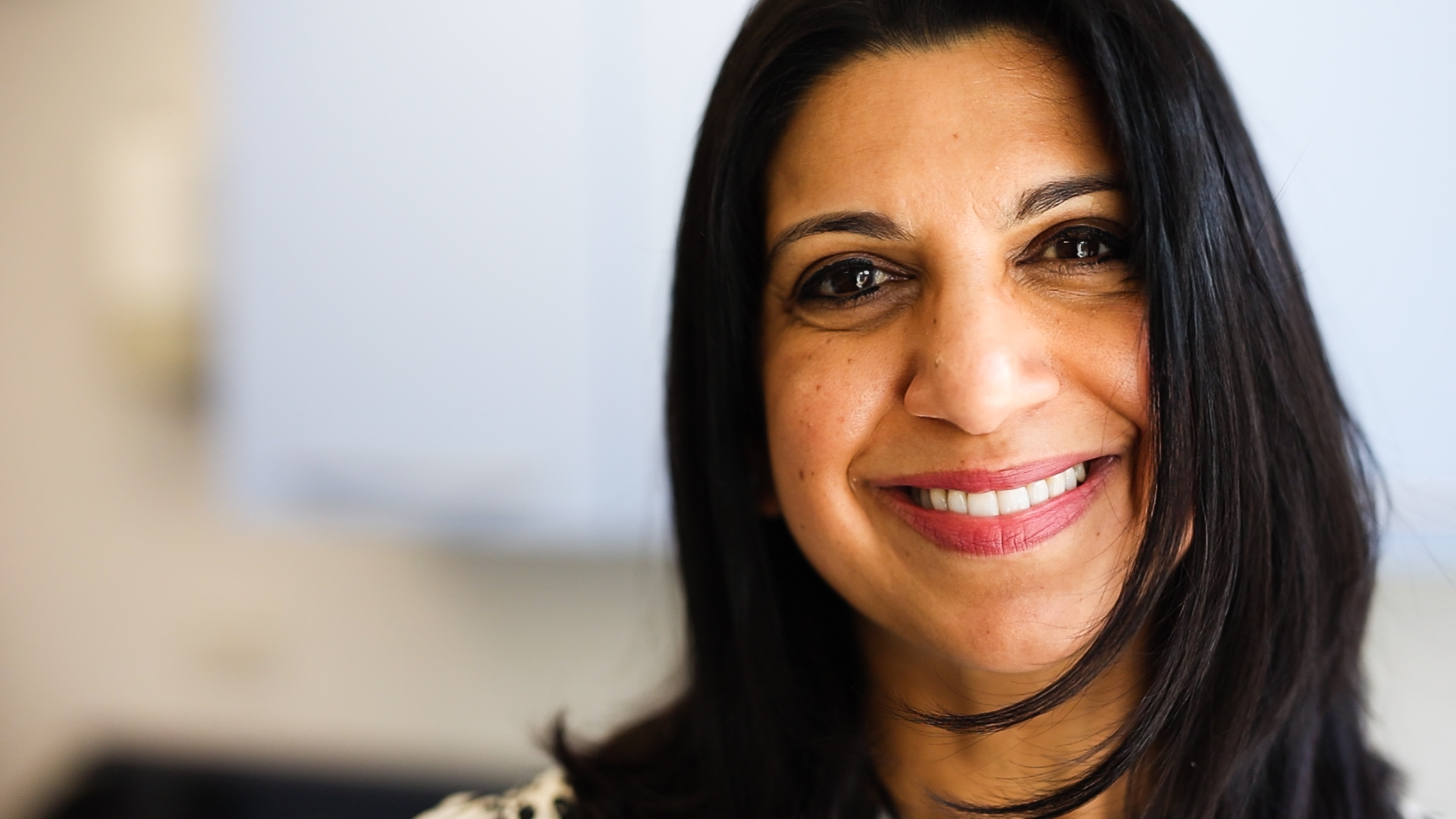 close up of female with brown eyes and brown hair smiling